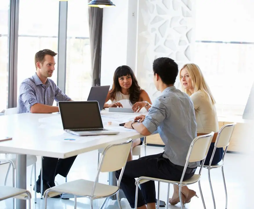 A group of people sitting around a table.