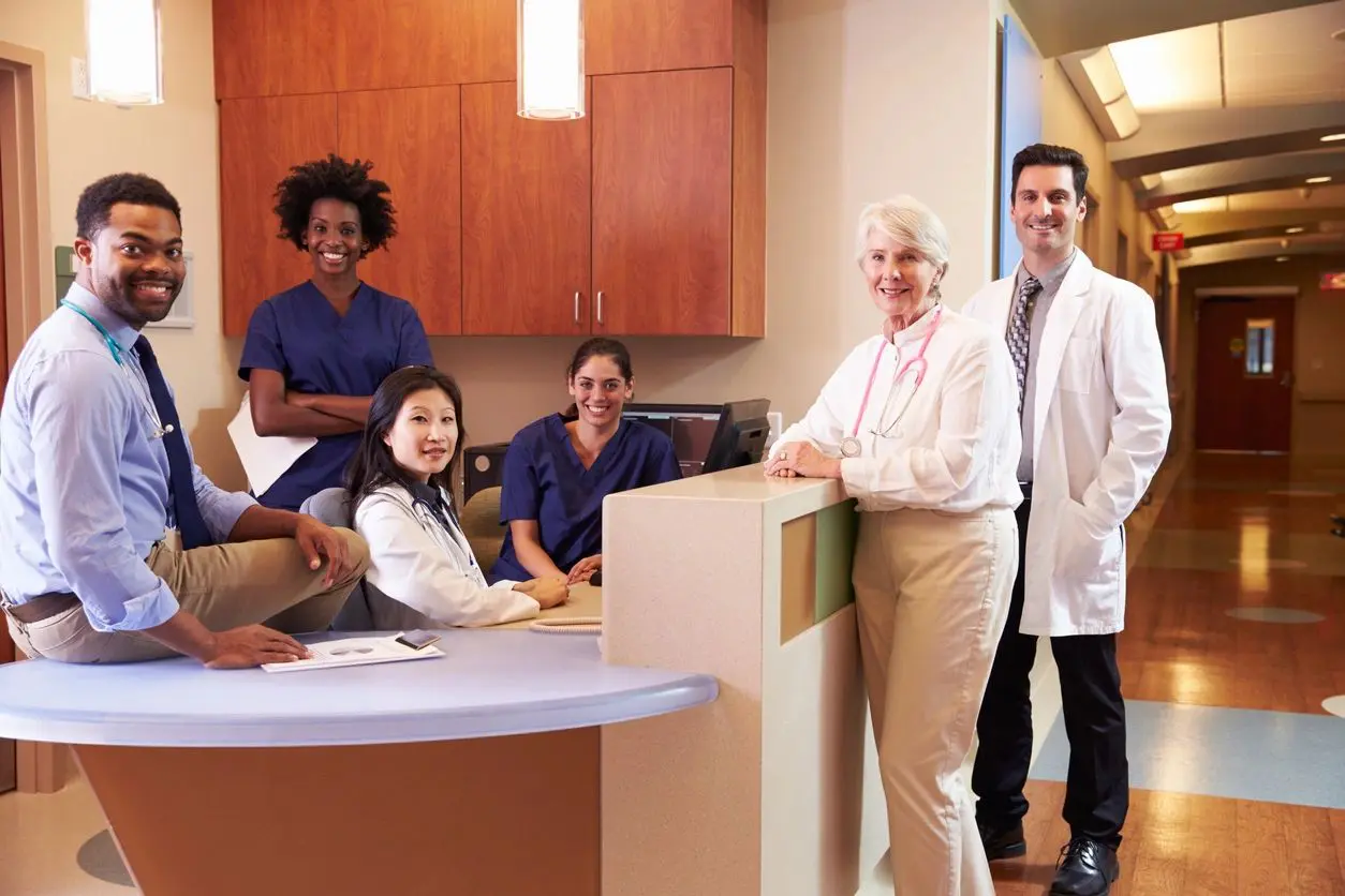 A group of doctors and nurses in the waiting room.